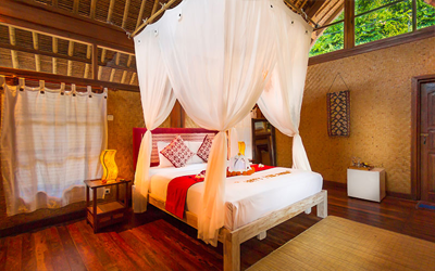 The Santai offers wooden bungalows with large romantic beds.