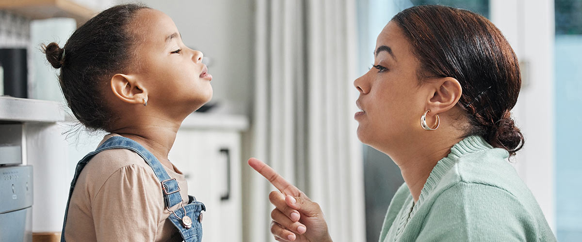 A mother speaks harshly to her daughter. Understand the difference between discipline and child abuse at mandatedreportertraining.com