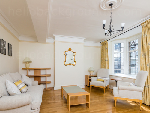 Light and airy living room featuring wooden flooring, two wooden chairs and sofa with cream upholstery Microsoft Teams background