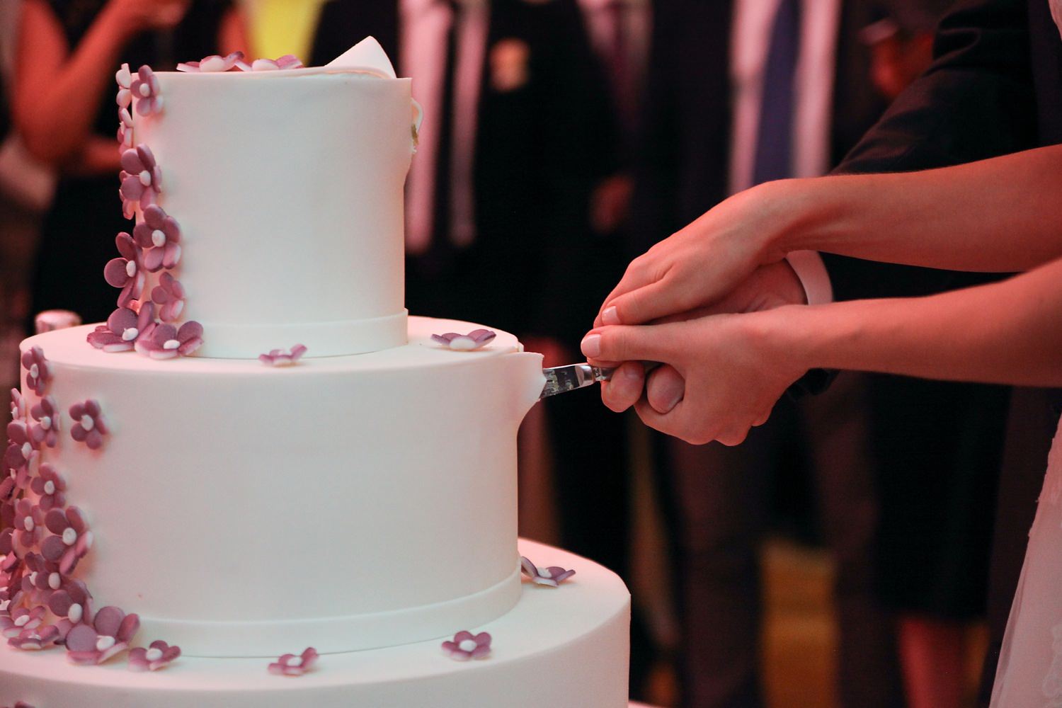A wedding cake being cut