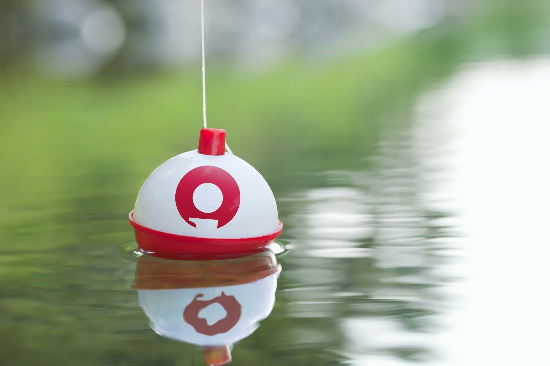 Fishing bobber with Insight logo sitting on the surface of water