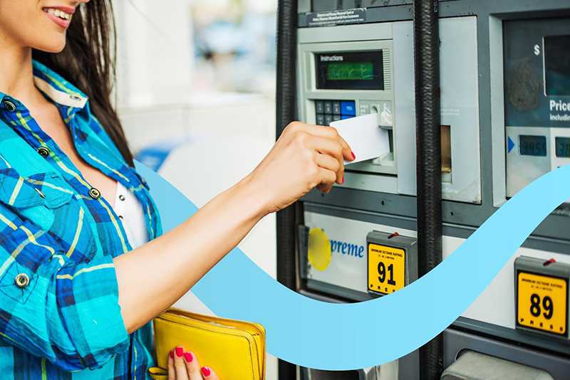 woman using a fleet card at the gas station