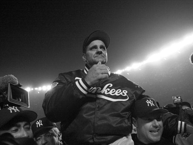 Joe Torre, manager of the victorious Yankees, is being held up by his World Series winning players