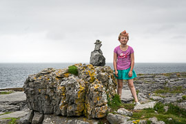 A reluctant Ayla poses next to a cairn near Lisdoonvarna.