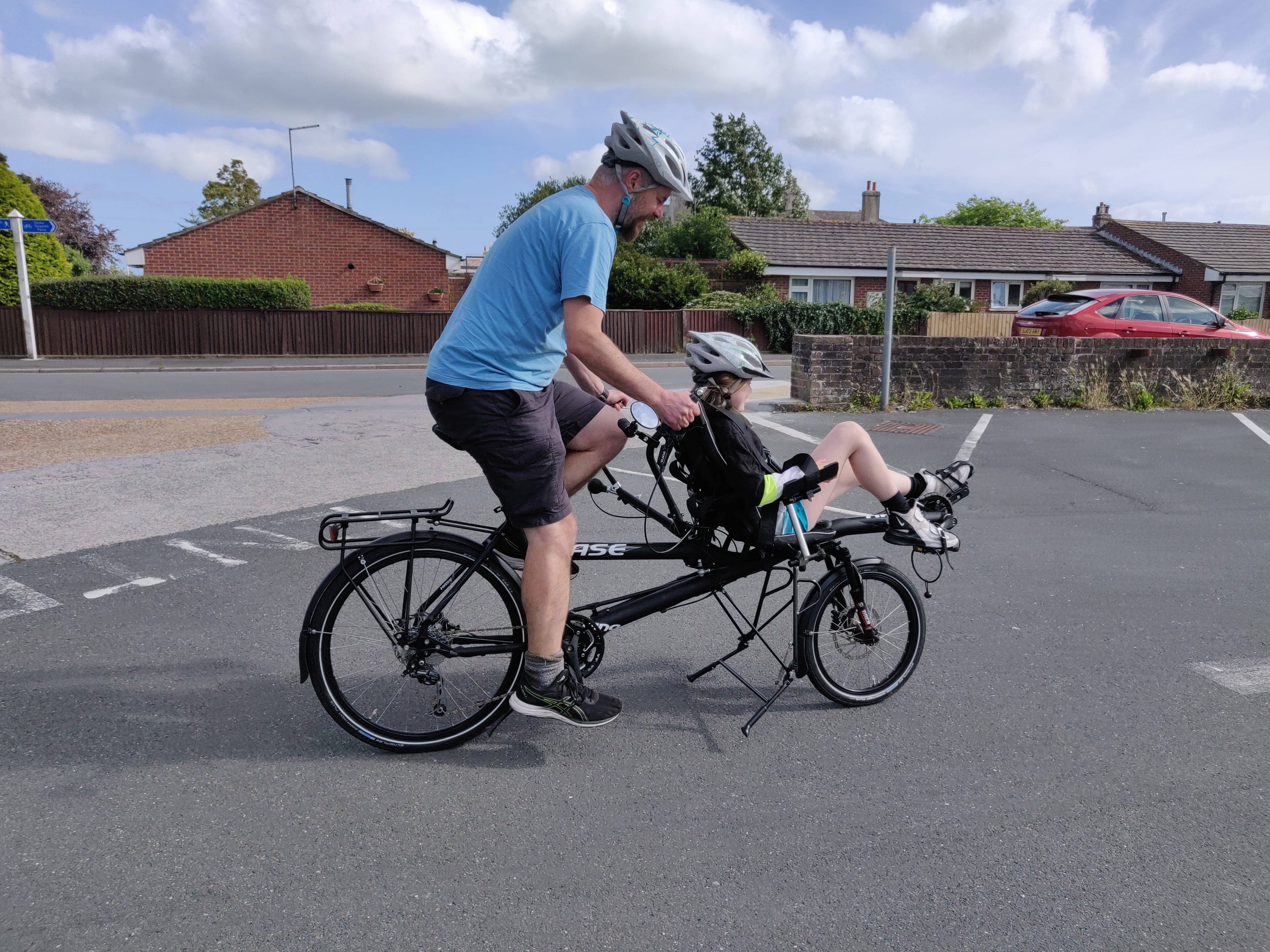 Me and my daughter on the recumbent tandem in a car park