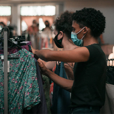 Two people browsing clothes