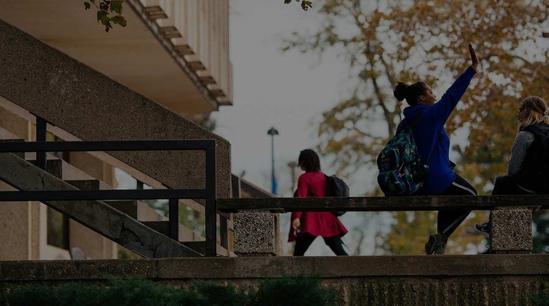 Students high fiving on the steps of the University of Kansas