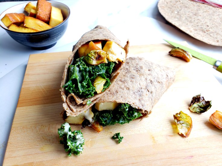 Tofu caesar salad wrap sliced in half