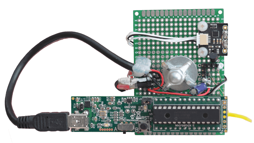 A prototyping board support a Microstick II board with the dsPIC 33EP128MC202. A board from Drotek endowing the Invensense ICM-20608 inertial sensor is screwed on the base board.