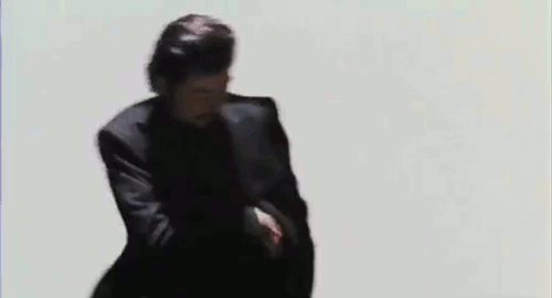 An animated gif of Kuroo (played by Tadanobu Asano), in a montage of pulling out guns and aiming at the screen against a white background. A scene from the movie 'Shark Skin Man and Peach Hip Girl'.