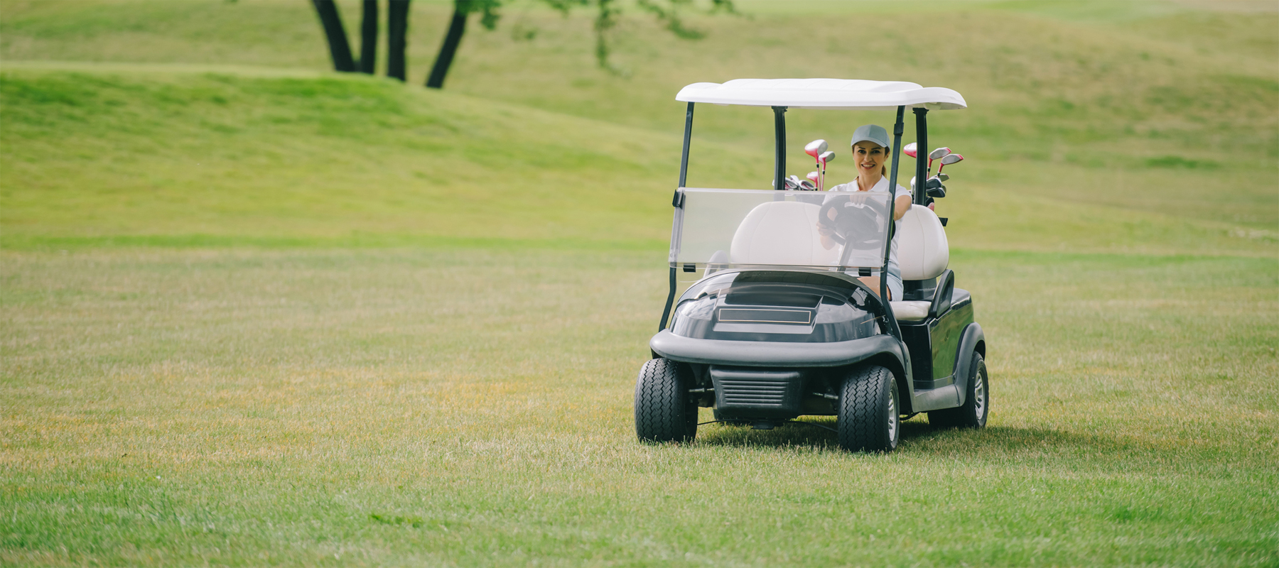 Woman in Used Golf Cart on Golf Course