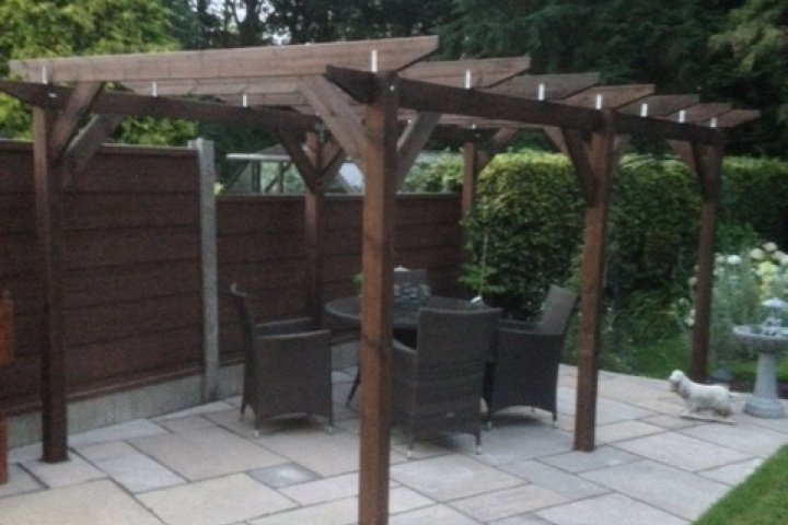 An example of module 5; a double length standalone pergola built on a patio, covering some wicker garden furniture