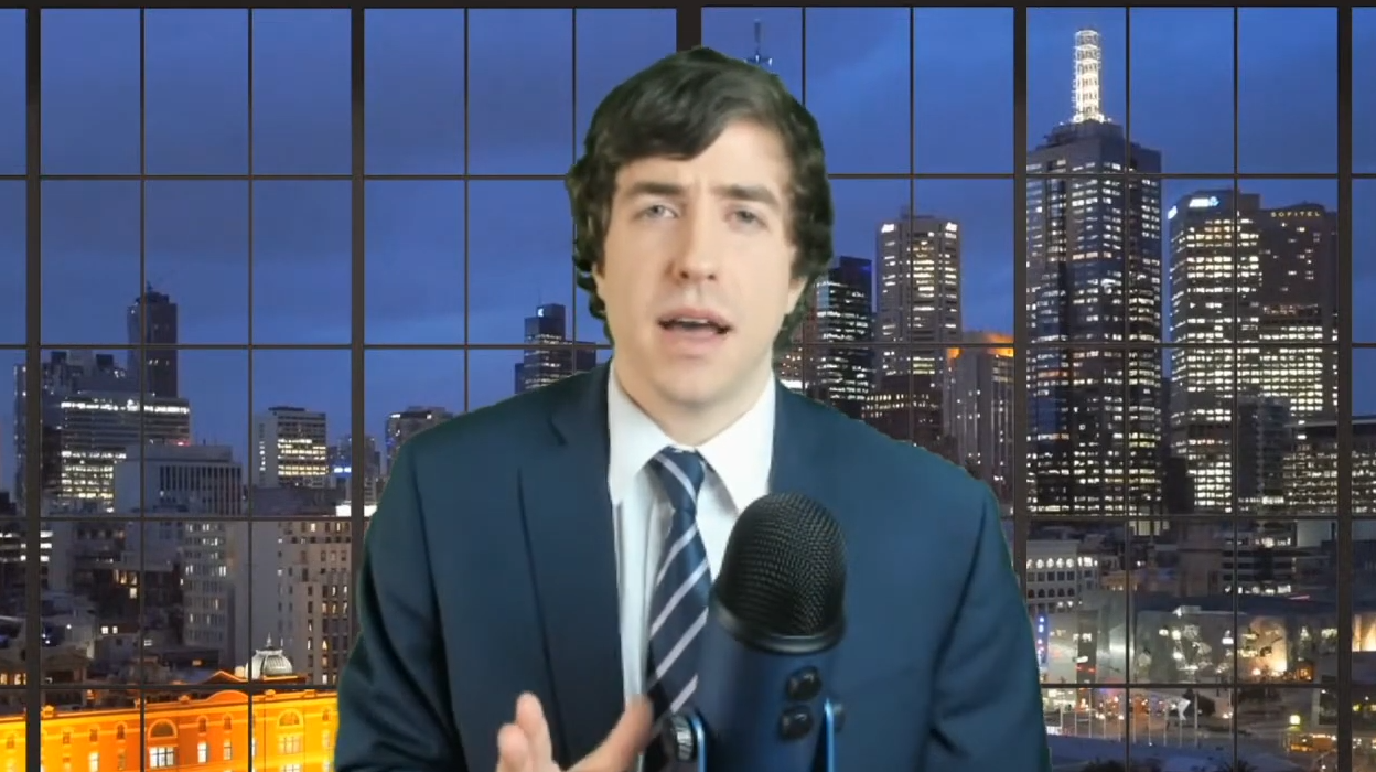 Patrick Casey on his Why I'm Not Going to AFPAC stream. He wears a suit and has a green screen
