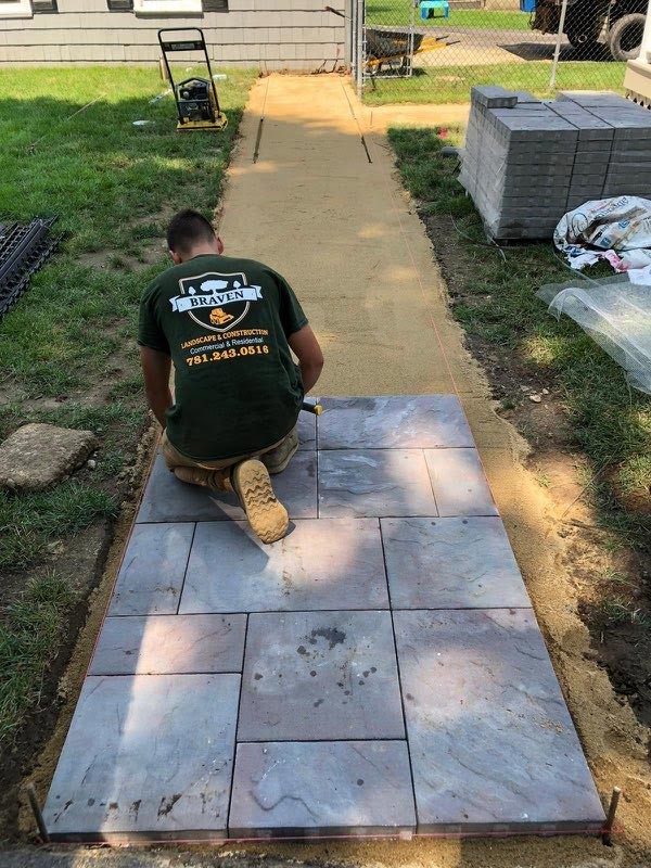 Henrique Almeida, the owner of Braven Landscape & Construction, working on a walkway.