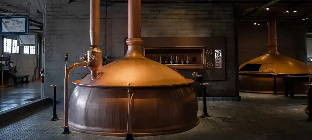 large copper kettle in a brewery by Claude Piché on Unsplash