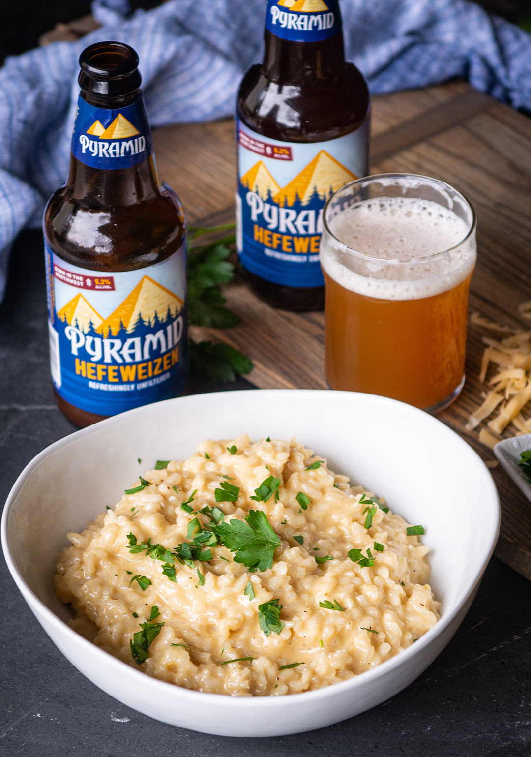 Bowl of Hearty Hefeweizen And Gouda Risotto with a bottle and glass of Pyramid Hefeweizen