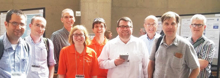 Michael Hirsch and geoscientists in poster hall at CEDAR 2015 Workshop.