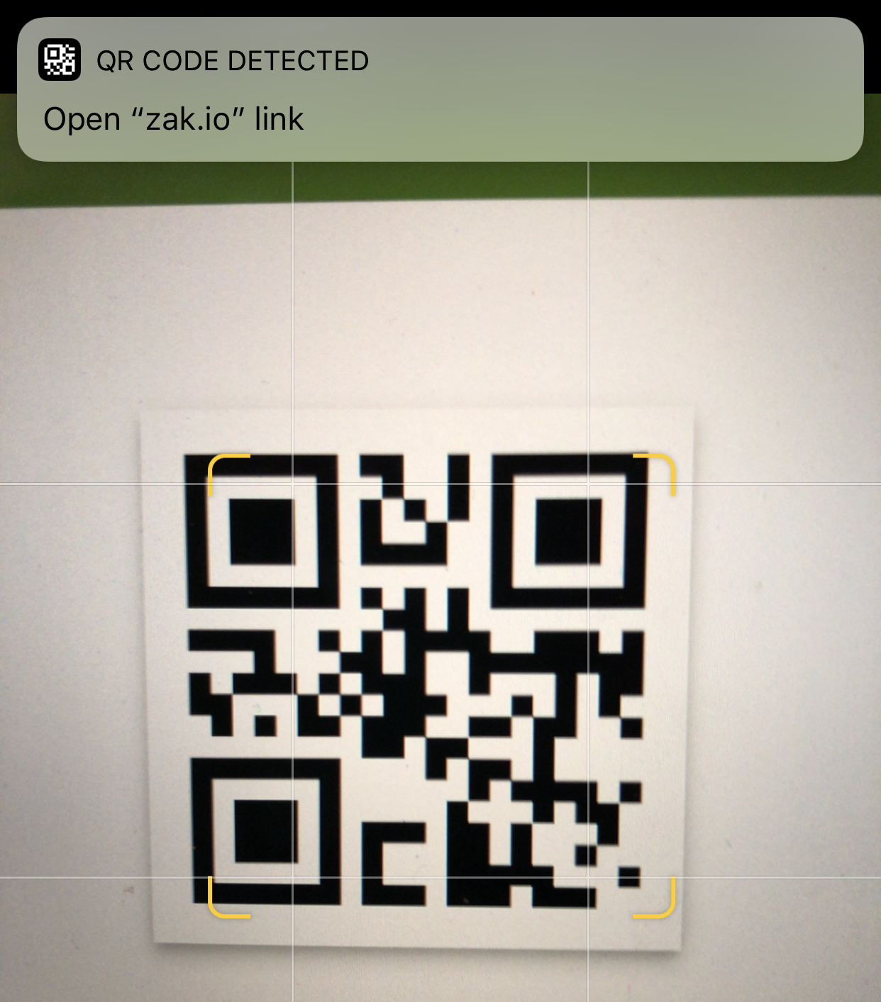 Screenshot of iPhone scanning QR code with banner at top of screen for user to navigate to scanned website