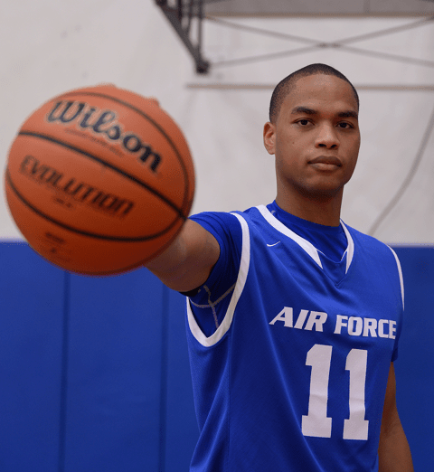 A player makes use of his opposable thumb to "palm" a basketball (Ollie Bradley)