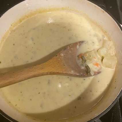 Slightly mash the soup with a wooden spoon/potato masher or use an immersion blender to *partially* blend the ingredients, this helps achieve a creamy texture without adding too much additional cream. Slowly pour in **1 cup heavy cream**, stirring constantly to help emulsify.