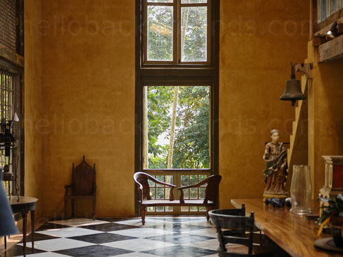 Spacious classically styled study room featuring a chessboard floor design with ornate wooden furniture and desk  Zoom background