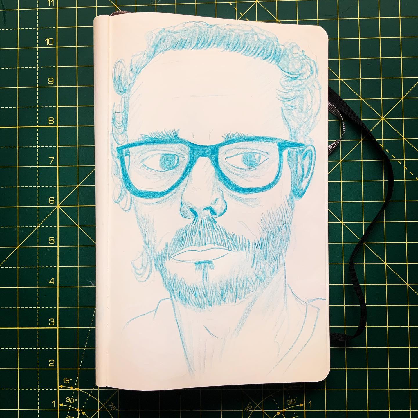 A self portrait by Adam Westbrook in blue polychromes pencil