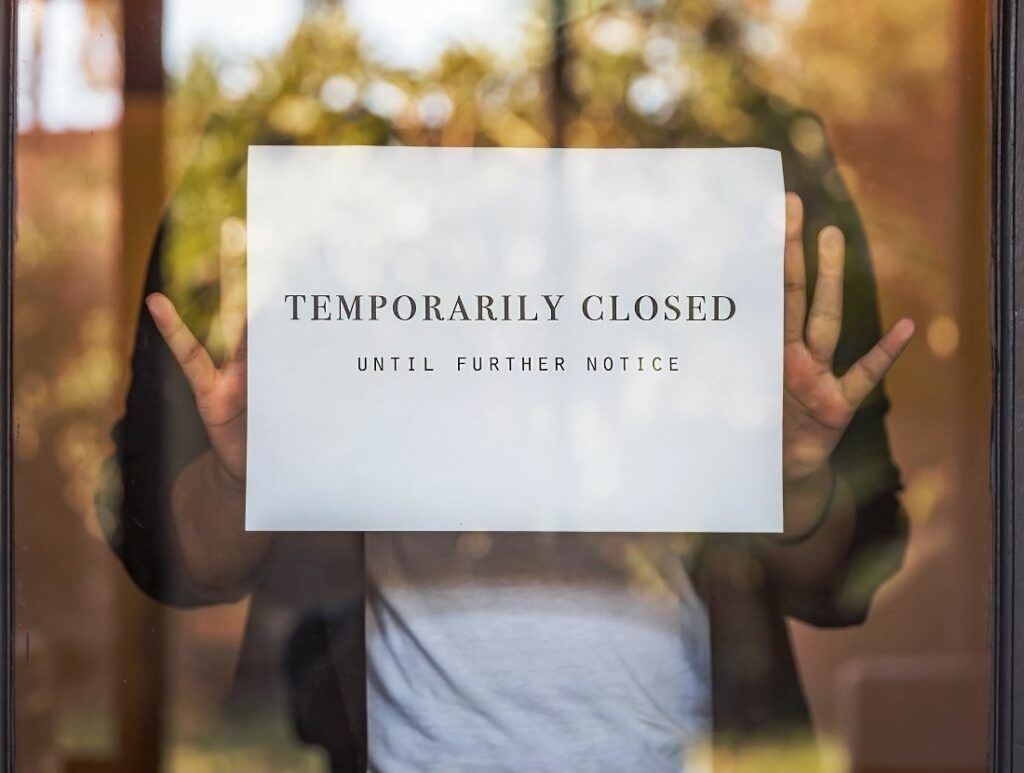 temporarily closed sign in shop window