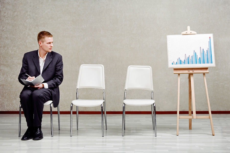 Business man sitting near a graph showing trends for search engine optimization and digital marketing in Austin