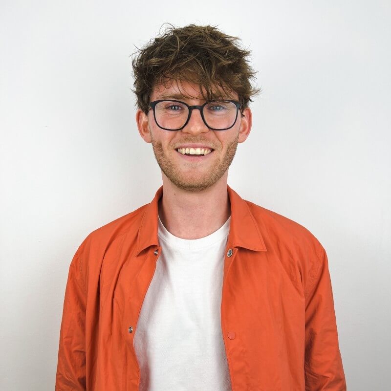 Profile picture of UX Designer, Niklas Missel, smiling in an orange jacket.