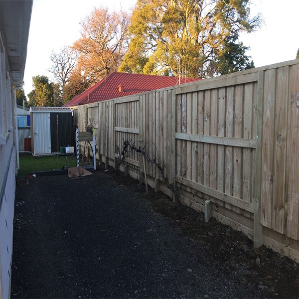 Timber capped retaining wall fence image