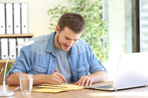 man writing physical address or mailing address